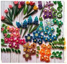 colorful paper flowers laid out on a wooden surface