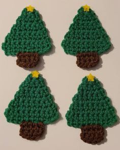 three crocheted christmas trees are shown in green and brown