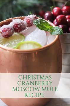 a christmas cranberry moscow mule recipe in a copper mug with lime and mint garnish