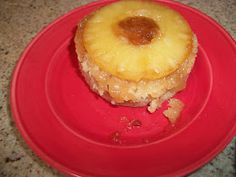 a pineapple upside down cake on a red plate