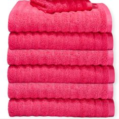 five bright pink towels stacked on top of each other