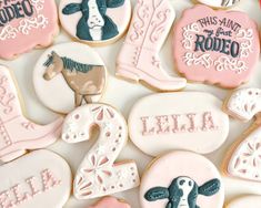 decorated cookies are arranged in the shape of horses, cowboy boots and boots with names on them