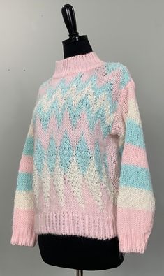 B E S T  F I T S    Suggested Size: 6/8  Please check measurements below to ensure the best possible fit.      D  E  S  C  R I  P  T  I  O  N     *Pink, white, and minty blue sweater  *Stripe and zig zag patterns  *Band collar  *Pullover  *Ribbed hemline and cuffs  *Hand knitted  *There is stretch to the item  *1980s - 1990s era    D  E  T  A  I  L  S     *Fabric:  100% Acrylic  *Care: Machine wash  *Marked Size: Medium  *Maker's Label: Margules      M  E  A  S  U  R  E  M  E  N  T  S     (Measu White And Blue Sweater, Sweater Stripe, Handmade Sweater, Spring Sweater, Hand Knitted Sweaters, White Hand, Zig Zag Pattern, Light Blue Sweater, Pullover Sweater Women