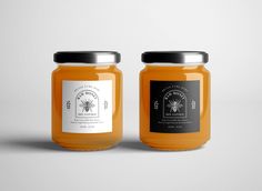 two jars of honey sitting side by side