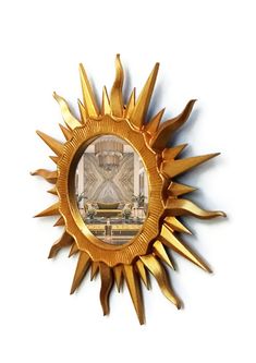 a gold sunburst with an image of a living room in the center on it