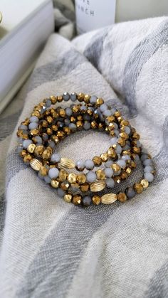 The  bracelet features beautiful faceted glass beads that are opaque grey with partial gold plating and three 18K gold plated beads.  This bracelet is on a stretchy cord, so it is easy to put on, stack, and elevates your outfit instantly! Measurements:  Diameter: 15 cm or 6 inches Need a different size? Convo me and I'll be happy to make you one in the size you need! Materials: Glass beads, 18K plated brass beads, stretchy cord. Gray Beaded Bracelets With Faceted Beads As A Gift, Gray Faceted Beads Bracelet As Gift, Gray Faceted Beaded Bracelets As Gift, Gold Rondelle Beaded Bracelet With Faceted Beads, Gold Crystal Rondelle Bracelet With Faceted Beads, Gray Faceted Beaded Bracelets For Gifts, Gold Stretch Bracelet With Faceted Beads, Gray Faceted Beads Bracelet For Gift, Brown Faceted Bead Bracelet