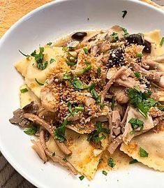 a white plate topped with pasta and mushrooms