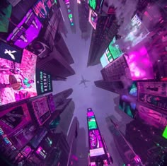 an aerial view of a city at night with neon lights and skyscrapers in the background