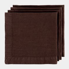 four brown napkins sitting on top of each other