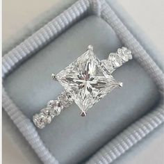 an engagement ring in a box with diamonds