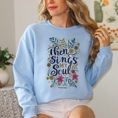 "Gift the Gift of Faith and Coziness with this Watercolor Floral Christian Sweatshirt | Unisex Crew Neck Sweater inspired by Psalm 'Then Sings My Soul' Introducing our Women's Watercolor Floral Theme Christian Unisex Crew Neck Cozy Sweatshirt!  This stunning sweater brings together the elegance of watercolor florals and the soul-stirring words from Psalm, Then Sings My Soul.   This cozy sweatshirt is the perfect combination of comfort and style. Stay snug and warm while proudly displaying your faith with this beautiful piece.  It also makes an ideal gift for that special Christian in your life. Embrace the beauty of faith and fashion with this remarkable sweater. Ideal for any situation, a unisex heavy blend crewneck sweatshirt is pure comfort. These garments are made from polyester and co Cozy Blue Top With Letter Print, Church Sweaters, Cozy Sunday, Bible Shirts, Then Sings My Soul, Sunday Church, Christian Sweatshirt, Christian Church, Floral Theme