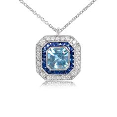 This platinum pendant features a bezel-set natural Asscher cut 1.05-carat aquamarine. The center stone is surrounded by halos of French cut calibrated sapphires and round brilliant cut diamonds, as well as fine milgrain. The geometric design is reminiscent of the Art Deco era.
The approximate dimensions of the aquamarine are 6.5mm.
If you have any questions about the Pacifica pendant, please feel free to contact us. Blue Platinum Necklace With Brilliant Cut, Blue Brilliant Cut Platinum Necklace, Blue Diamond Cut Platinum Necklace, Blue Halo Platinum Jewelry, Platinum Pendant, Estate Diamond Jewelry, French Cut, Aquamarine Engagement Ring, Asscher Cut