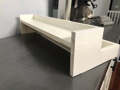 a white shelf sitting on top of a counter