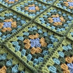 there is a crocheted blanket with flowers on it