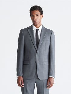 A refined look with tailored, slim fit shaping, this Calvin Klein blazer jacket is made from four-season wool with natural stretch and a subtly textured design. Lightly padded shoulders, notch lapels, a 2-button front, 4-button cuffs and multiple front pockets finish this timeless yet modern look.  Material: 100% Wool. Grey Suit Jacket, Grey Suit, Four Season, Textured Design, Jacket Buttons, Sport Coat, Blazer Jacket, Heather Grey, Suit Jacket