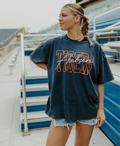 The Band Tee is one of the comfiest garments we make, featuring a very oversized and roomie fit. This Band Tee is bound to be your new go-to! Dress it up with denim shorts and booties - or pair it with biker shorts and sneakers for a more relaxed look. Oversized Embroidery & ScreenPrint 100% Washed Cotton Trendy Oversized Top For Game Day, Summer Collegiate Relaxed Fit Tops, Relaxed Fit Collegiate Summer Tops, Collegiate Style Summer Tops With Relaxed Fit, Summer Collegiate Style Tops With Relaxed Fit, Oversized Cotton Tops For School Spirit, Relaxed Fit Tops For School Spirit Streetwear, Relaxed Fit Tops For Streetwear With School Spirit, Oversized Tee