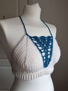 This one of a kind bralette will make you stand out wherever you go!  Featuring:  Deep V blue shell detailing! White ribbing around the waist! A criss cross back! Made in both white and turquoise 100% acrylic yarn.  Perfect for festivals with high waisted denim shorts or harem pants!  Bralette pictured is made to fit size medium and is ready to dispatch!  Please note, ALL OTHER SIZES WILL BE MADE TO ORDER AND DISPATCHED WITHIN 14 DAYS OF PURCHASE!  Full Sizing details:  Small - A-B cup  Medium - Bohemian Crop Top With Built-in Bra For Festivals, White Halter Neck Crop Top With Built-in Bra, Festival Halter Neck Crop Top, Bra Friendly, Festival Halter Neck Crop Top Bra Friendly, Festival Bra Friendly Cropped Top, White Triangle Top Bra Friendly, White Triangle Top With Bra-friendly Design, White Triangle Top With Bra Friendly Design, Summer White Crop Top, Bra Friendly