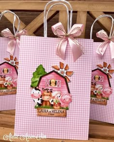 three pink bags with farm animals on them