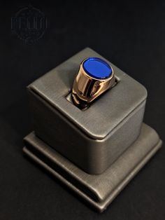 Stainless Steel Rings: Elevate your style with our Luxurious Men's Gold Stainless Steel Signet Ring featuring a striking blue stone. This bold and sophisticated ring is perfect for making a statement, whether you're dressing up for a special occasion or adding a touch of elegance to your everyday attire. Material: Gold Plated Stainless Steel Stone: Vibrant Blue Stone Design: Bold and sophisticated signet ring style Features: Hypoallergenic, suitable for sensitive skin Perfect For: Daily wear, sp Luxury Men's Rectangular Gemstone Ring, Blue Oval Signet Ring For Promise, Blue Oval Signet Promise Ring, Modern Blue Sapphire Jewelry, Luxury Blue Rings With Polished Finish, Sapphire Signet Promise Ring, Modern Blue Oval Signet Ring, Modern Blue Round Band Ring, Modern Blue Sapphire Ring For Formal Occasions