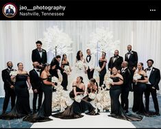 a large group of people in formal wear posing for a photo