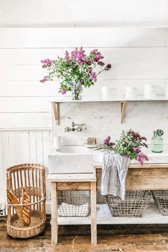 a bathroom with two sinks and baskets on the floor