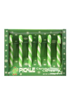 four green and white striped candles in a christmas display box with snowflakes on the sides