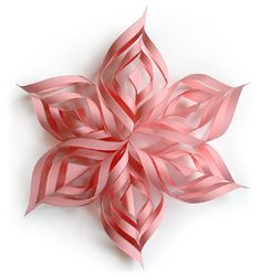 an ornament shaped like a flower on a white background