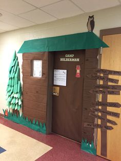 a classroom door decorated to look like a cabin