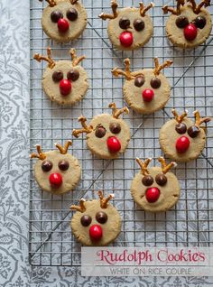 rudolph cookies with pretzels and chocolate chips are arranged on a wire cooling rack