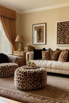 a living room filled with lots of furniture and animal print on the pillows in front of windows