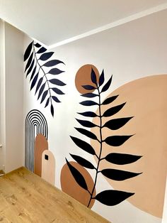 the wall is painted with black and white leaves on it, along with an orange circle