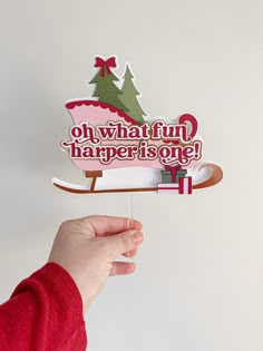 a person is holding up a christmas ornament that says oh, what fun happened there?