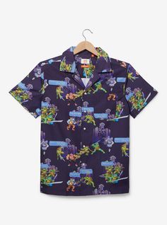 Get out of the sewers and to the beach with this Teenage Mutant Ninja Turtles top! Featuring an allover print of the turtles fighting their enemies in 8-bit style  this shirt includes a button front and pocket  perfect for your next summer adventure.A BoxLunch Exclusive!PolyesterListed in unisex sizesWash cold with like colors; dry lowImported Summer Shirt With Relaxed Fit And Character Print, Cotton Character Print Beach Top, Summer Relaxed Fit Shirt With Character Print, Cotton Character Print Tops For Beach, Beach Cotton Top With Character Print, Cotton Beach Top With Character Print, Summer Vacation Tops With Character Print, Beach Shirt With Multicolor Graphic Print, Multicolor Print Cotton Shirt For Beach