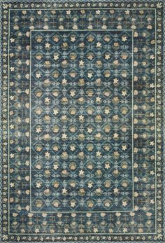 a blue rug with an intricate design on the center and sides, in different colors