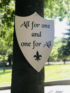 a sign on a tree that says,'all for one and one for all '