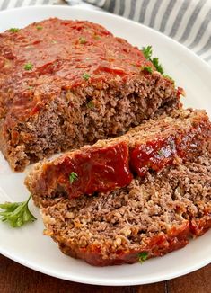 meatloaf with marinara sauce on a white plate