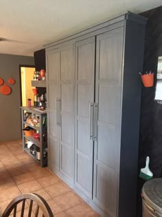 a kitchen with gray cabinets and tiled flooring