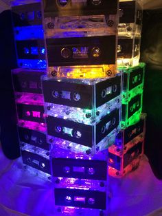 a stack of cassettes sitting on top of each other in front of a purple light