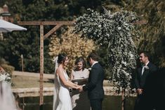 a bride and groom standing at the alter during their wedding ceremony