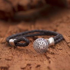 Designed by Balinese artisan Henry Anthony Sanny, this men's bracelet brings a Viking spirit wherever it goes. The bracelet circles the wrist with two cords of hand-braided black leather cord, centered by a sterling silver pendant that depicts the Uunartoq disc, or "Viking compass." Mens Sterling Silver Jewelry, Runic Compass, Leather Bracelet Men, Leather Pendant, Compass Bracelet, Bracelet Viking, Viking Bracelet, Bracelet Men, Men's Bracelet