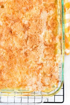 a casserole dish on a cooling rack with a yellow and white checkered napkin