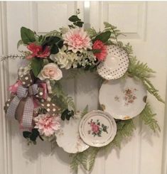 a wreath made out of plates and flowers