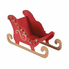 a red wooden sleigh with gold studs on the handles and sides, sitting upright