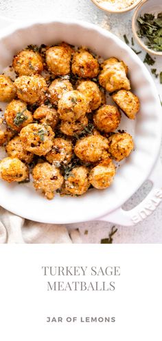 a white bowl filled with meatballs on top of a table