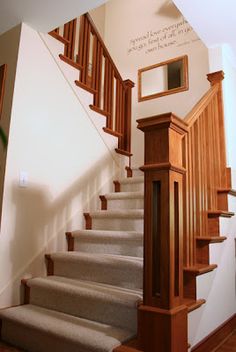 the stairs are made of wood and have carpeted treads on each one side