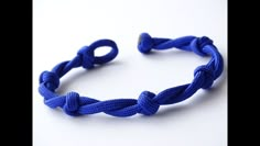 a blue rope bracelet on a white surface