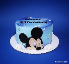 a mickey mouse birthday cake on a blue background