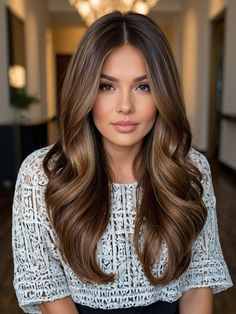 Brunettes looking to brighten their summer can’t go wrong with these glamorous, voluminous waves highlighted with a gradient of blonde ambition. Starting with a rich brunette root, the waves cascade into a fusion of honey and caramel blonde tones. This style radiates sophistication and would suit any sun-drenched summer activity, from a casual beach day to an upscale evening soiree. Brunette Hair Side Part, Side Portion Hairstyle, 2024 Fall Brunette Hair Trends, Creamy Beige Balayage, Hair Color For Deep Autumn Skin Tone, Collarbone Length Brown Hair, Summer Hair Color Brunette, Hair Color For Pale Skin And Hazel Eyes, Teddy Bear Brunette