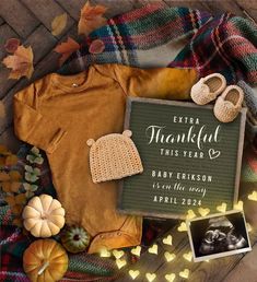 a baby announcement is displayed on a blanket with fall leaves and pumpkins around it