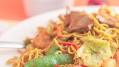 a white plate topped with noodles and veggies